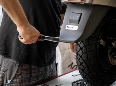 Man using torque wrench on motorbike