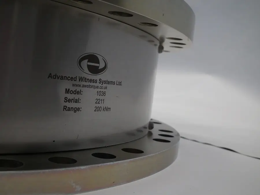 AWS logo on an AWS annular torque transducer on a white background