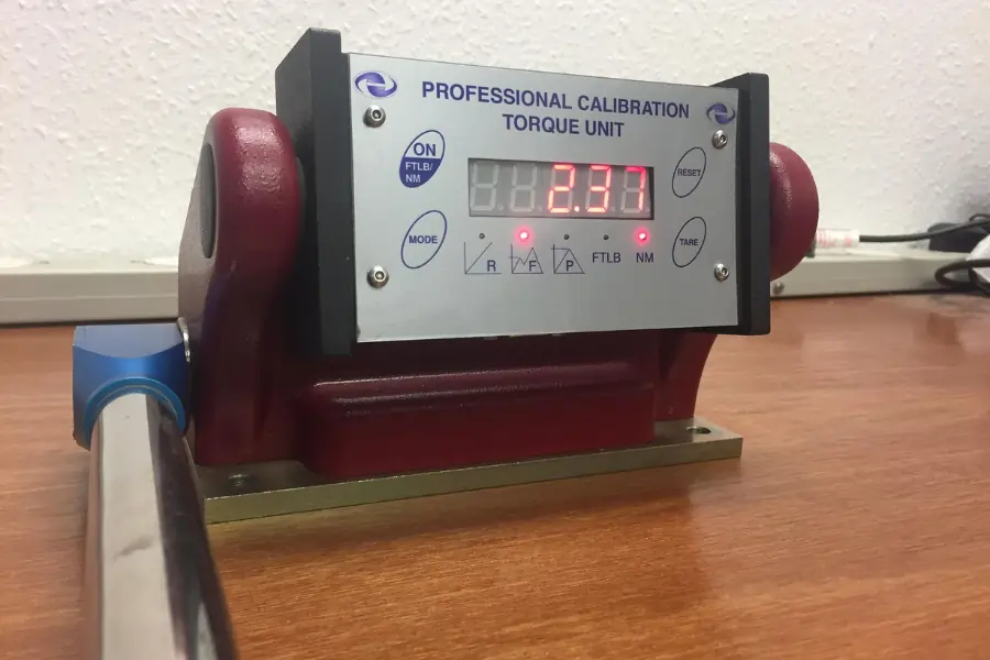 AWS red torque tester with a torque wrench in