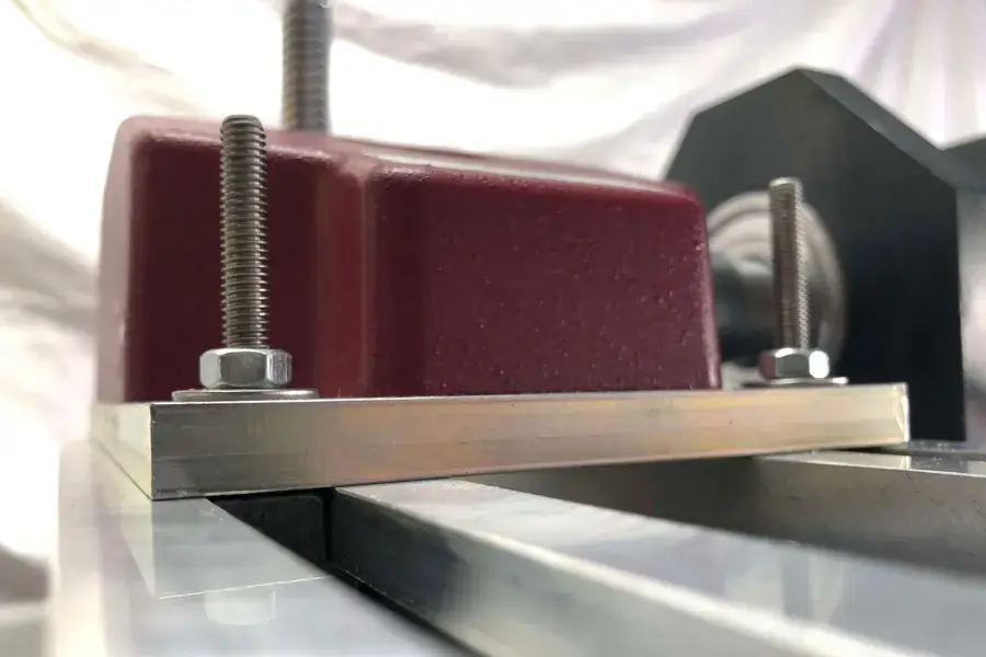 Close up of bolts that are mounting a torque tester to a surface