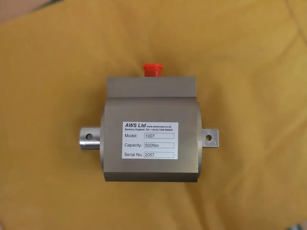 Side on view of rotary torque transducer with yellow background