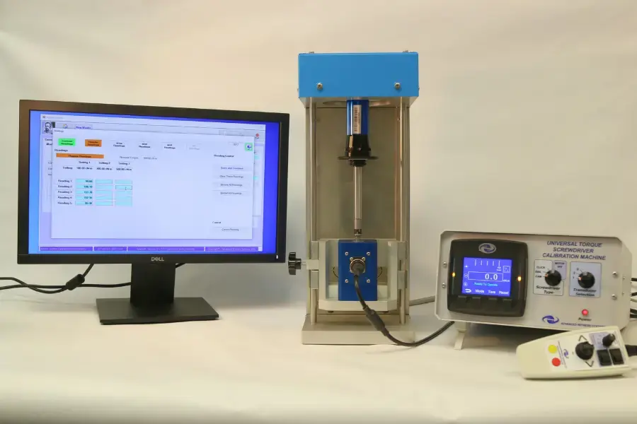 Computer running torque calibration software next to the a torque screwdriver tester