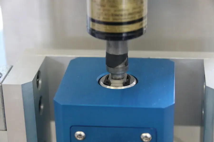 Close up of torque screwdriver applying torque to a torque transducer in a calibration machine