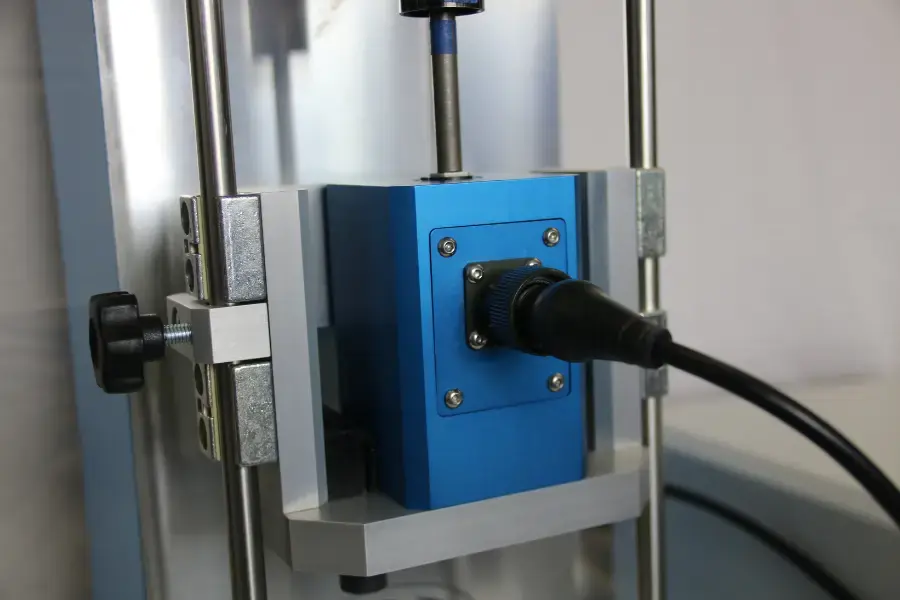 Blue Inline torque transducer in a torque screwdriver calibration machine