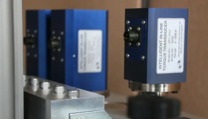 Three blue torque transducers lined up in a row