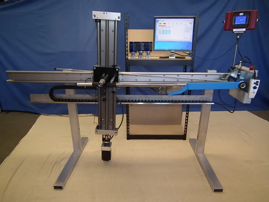 AWS torque wrench calibration machine in front of blue backdrop